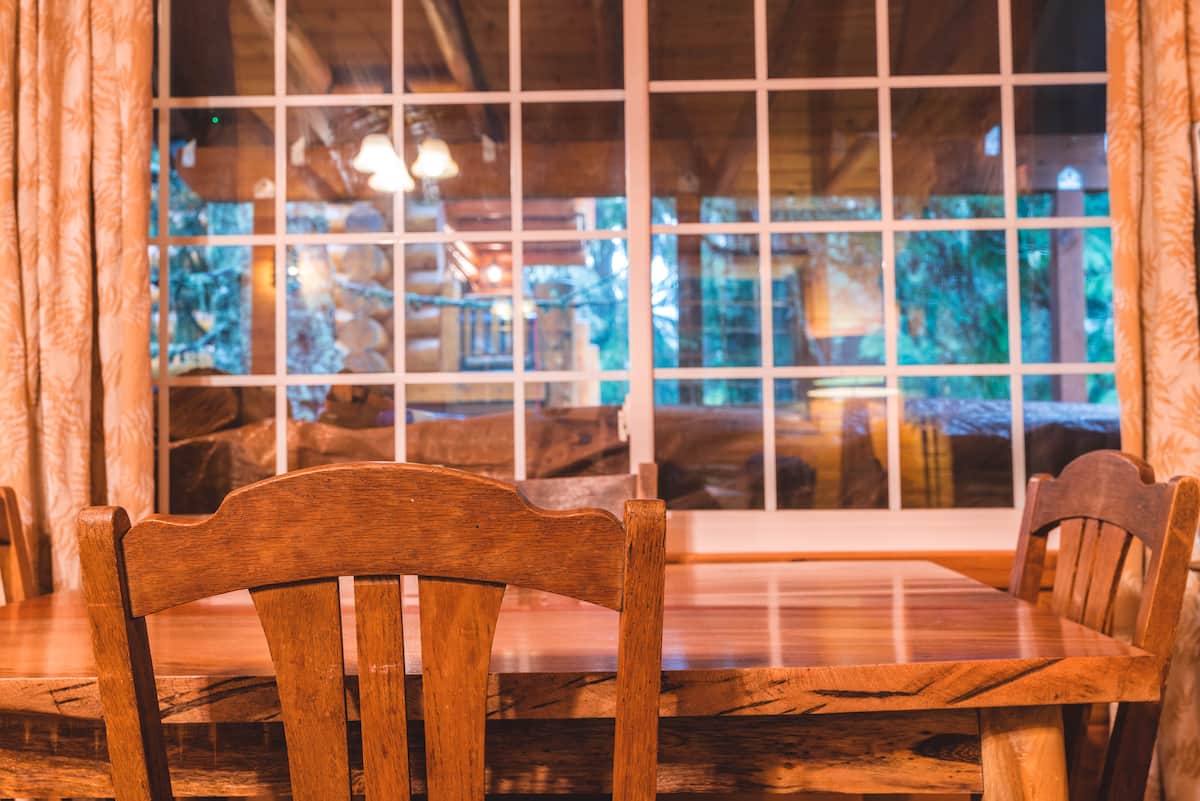 Wood dining table beside the living room window