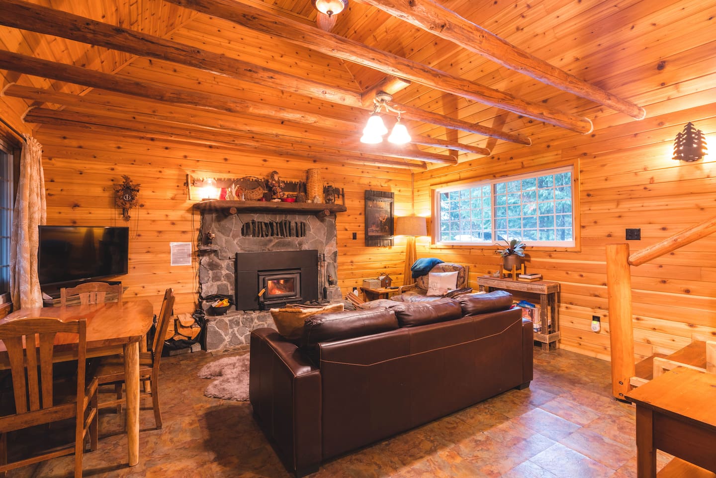 Wide view of the timber main room and fireplace