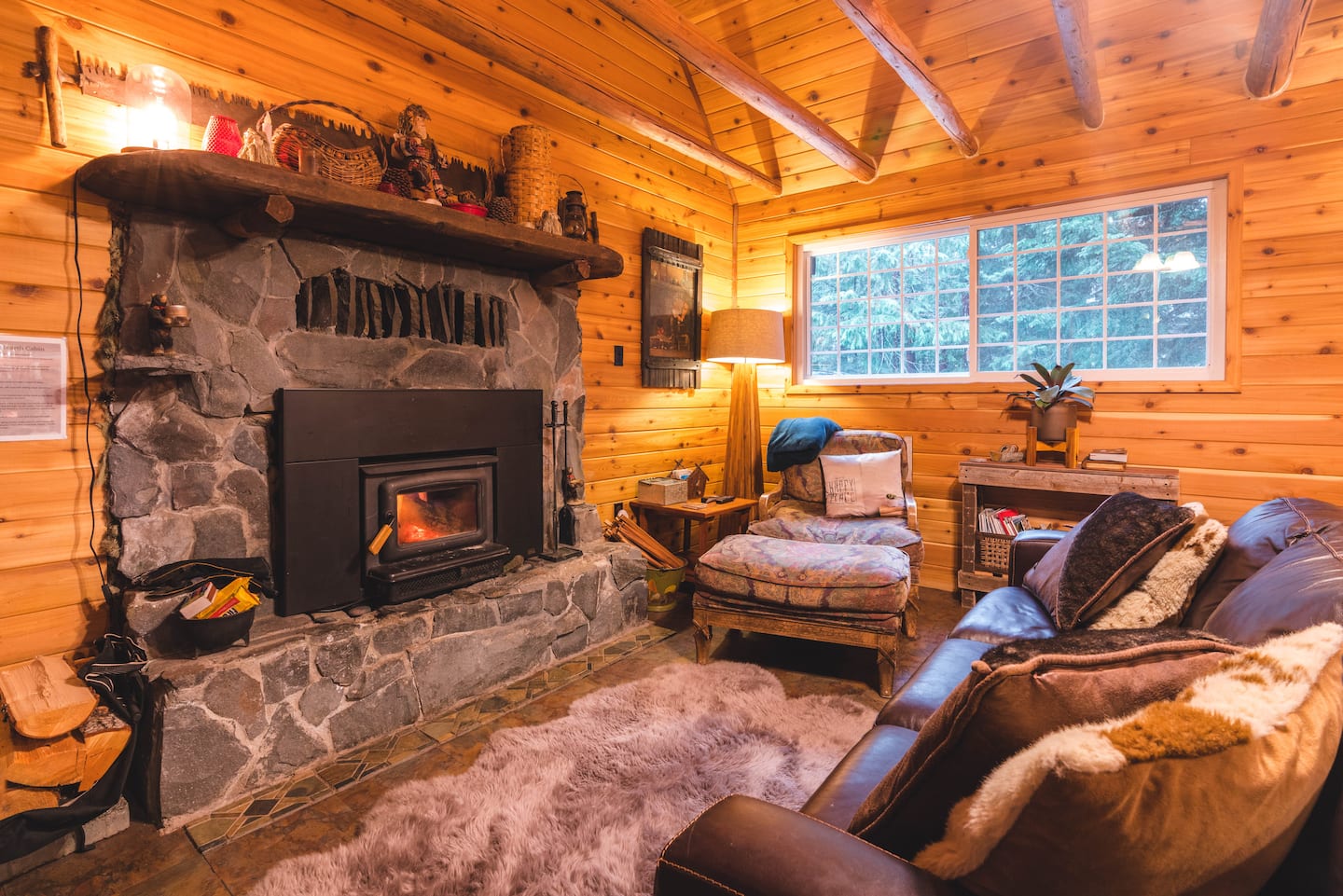 Alternate angle of the stone fireplace and living room seating