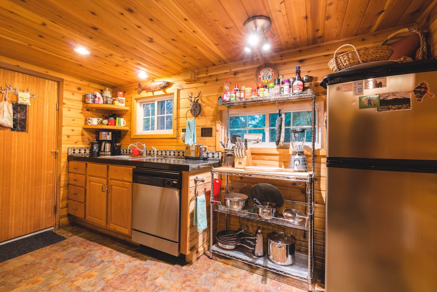 Reverse kitchen angle showing refrigerator, dishwasher, and counter
